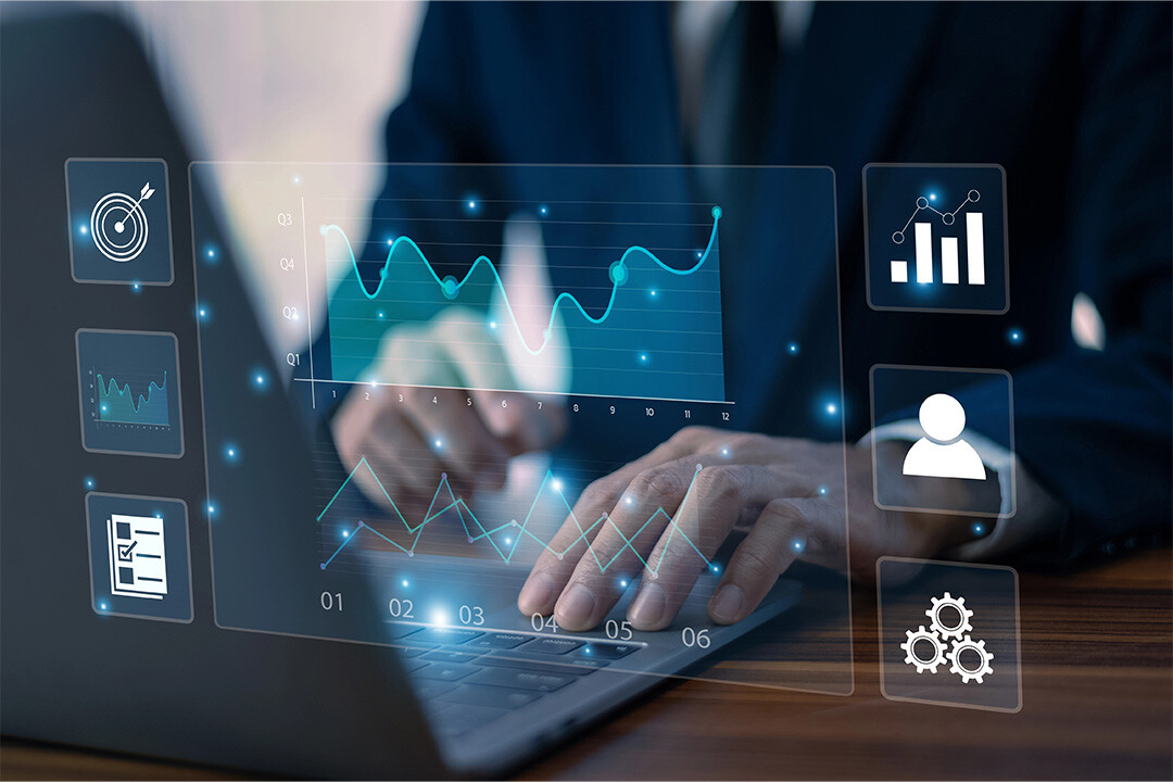 A person works on a laptop with a touch screen with predictive analytics