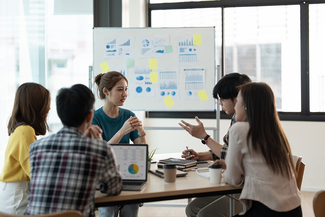 A group of young professionals discussing predictive modeling and data privacy