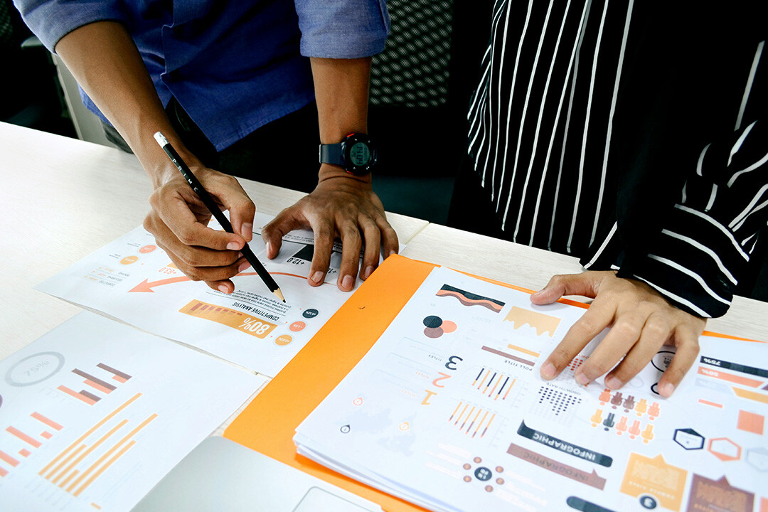 A group of professionals analyzing data from tracking consumer actions.